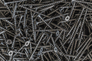 Industrial background of many black metal scres closeup. Tools series.