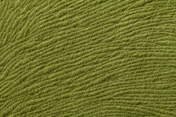 Green olive background from soft textile material. Fabric with natural texture.
