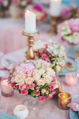 Table setting at a luxury wedding decorated with composition of