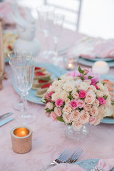Table setting at a luxury wedding decorated with composition of