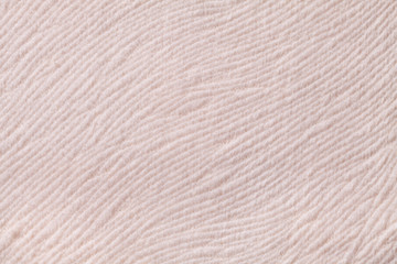 Light beige background from soft textile material. Fabric with natural texture.