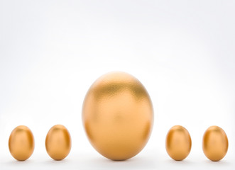 Investment Concept With Large And Small Golden Eggs