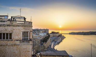 Valletta, Malta - Panoramic skyline view of sunrise in Malta with the ancient walls of Valletta and...
