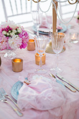 Table setting at a luxury wedding decorated with composition of