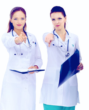 Two woman  nurse watching X Ray image and pointing to you , standing in hospital
