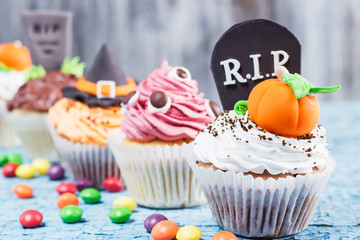 Halloween cupcakes with different colored mastic decorations