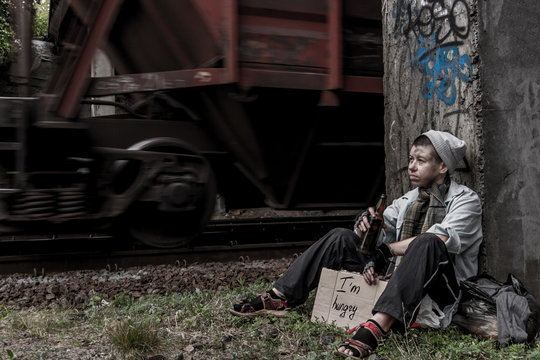 Homeless woman near the rail track