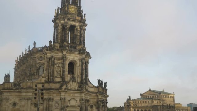 Tilt up Katholische Hofkirche with Theaterplatz and Semperoper in the background. Dresden Germany