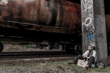Homeless woman near the rail track