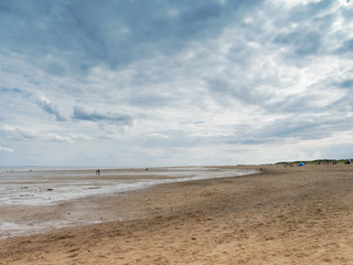 Dark clouds gather over an almost deserted Skegness beach in Lincolnshire