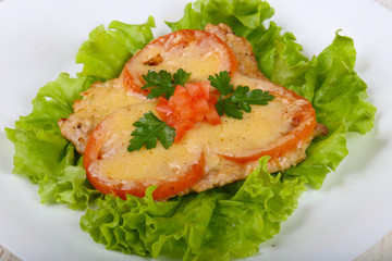 Pork baked with tomato and cheese