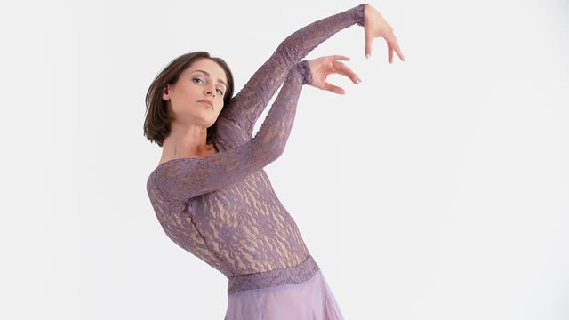 Young Woman in a Purple Dress Dancing Modern Contemporary Style on a White Background