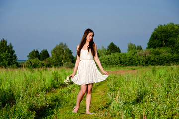 the girl walks in the field