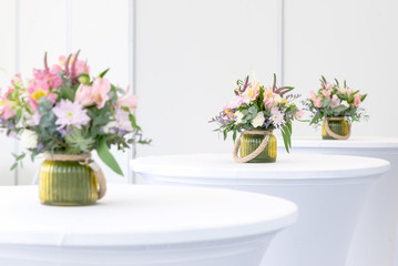 beautiful flower arrangement on white festive tables