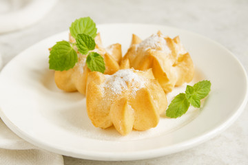 profiteroles with cream and powdered sugar