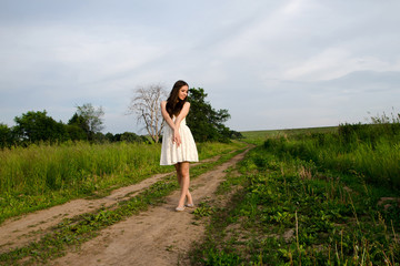 girl in white dress on the footpath