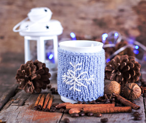 Cup with hot drinks, cones, nuts, gift.