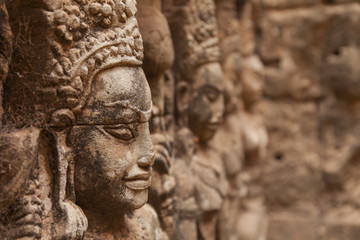 Fototapeta na wymiar Terrace of leper king, close up detail of the carving of the walls. Angkor, Cambodia.