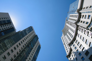 Fototapeta na wymiar Two high-rise buildings in sunlight rays