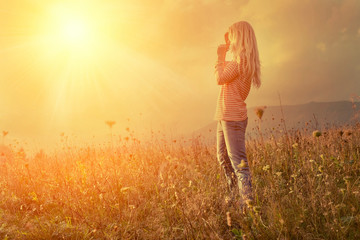 Happiness woman stay outdoor under sunlight of sunset