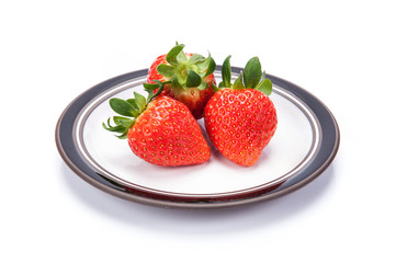 fresh garden strawberries on a white plate