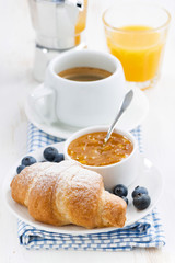 fresh croissant with orange jam, blueberries and coffee 