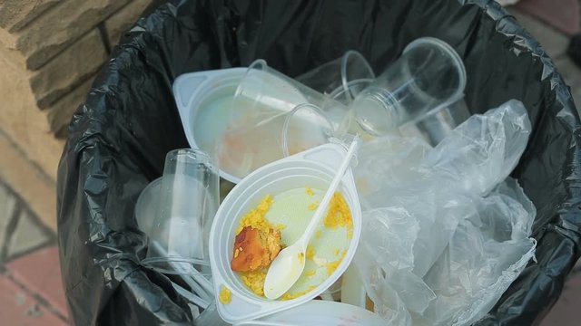 Dirt Plastic tableware in the bin