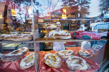 confectioner preparing a counter with cakes