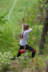 female archer aiming at a target outdoors