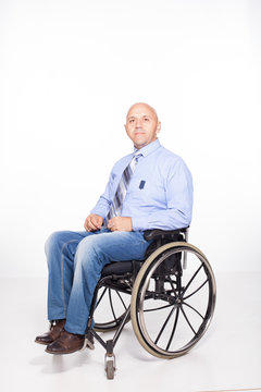 Disabled man in an office suit is preparing to start work.