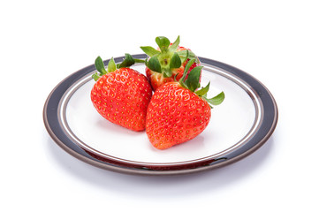 fresh garden strawberries on a white plate