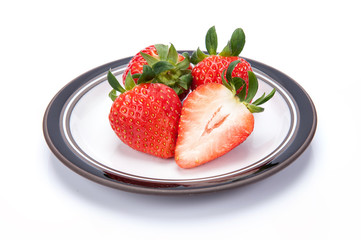 fresh garden strawberries on a white plate