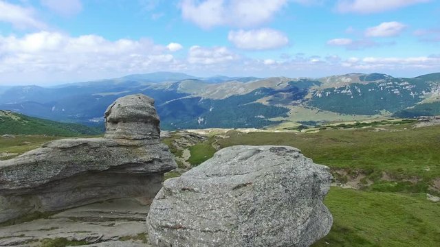 Aerial flight over Babele natural monument on Bucegi plateau, Romania, tilt