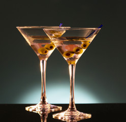 Two glasses with martini , focus on a olives