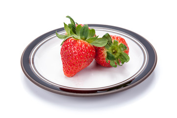 fresh garden strawberries on a white plate