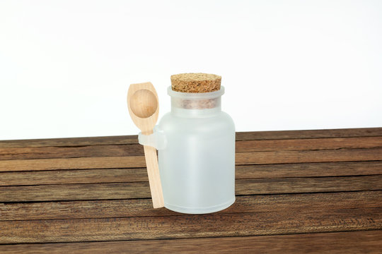 White Plastic Bottle With Wooden Spoon