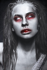 Girl in the form of zombies, Halloween corpse with blood on his lips. Image for a horror film. Photos shot in studio