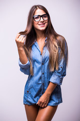 Beautiful girl in jeans shirt with glasses posing with different gesture in studio
