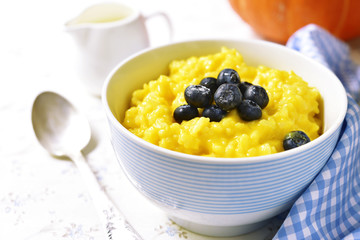 Rice porridge with pumpkin and fresh blueberry.