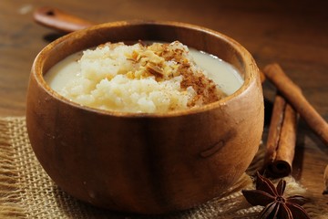 Rice pudding topped with nuts and cinnamon powder, selective focus