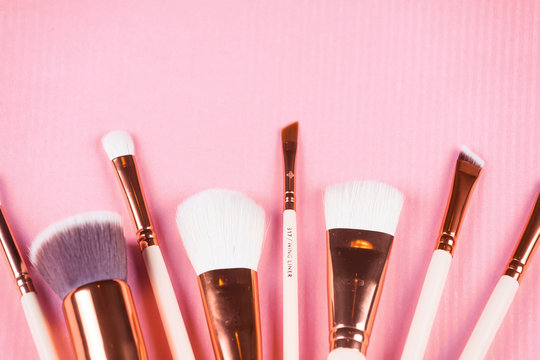 Face makeup brushes on pink.