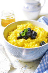 Rice porridge with pumpkin and fresh blueberry.