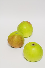 red green apples on white background