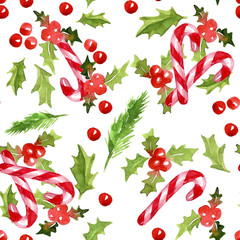 Christmas holly leaves and berries and candy canes on a white ba - 121367219