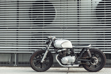 motorcycle standing in dark building in rays of sunlight