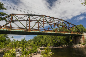 Rusty bridge over river, Sebago Lake, Maine