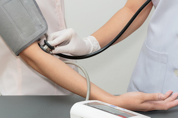 Doctor and patient. Measurement of blood pressure in a hospital
