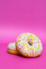 Donuts glazed on a pink background