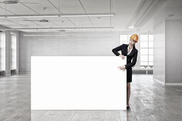 Fototapeta premium Woman engineer with banner . Mixed media