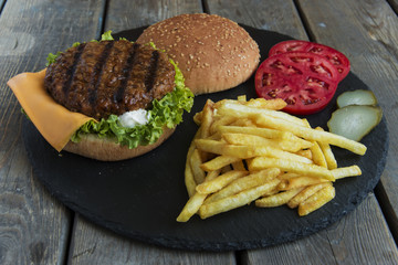 Beef hamburger  grill french fries pickled cucumber tomato cheese